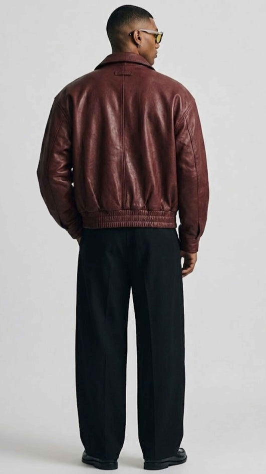 Back view showing dropped shoulders and baggy relaxed fit of dark red genuine leather flight jacket.