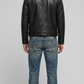 Model wearing a stylish black crocodile textured leather coat paired with blue denim jeans.