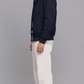 Side angle view showing adjustable cuff closures and relaxed sleeve fit on dark navy blue cotton jacket
