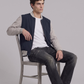 Men's casual streetwear look showcasing a modern two-tone navy blue and grey lightweight cotton jacket.