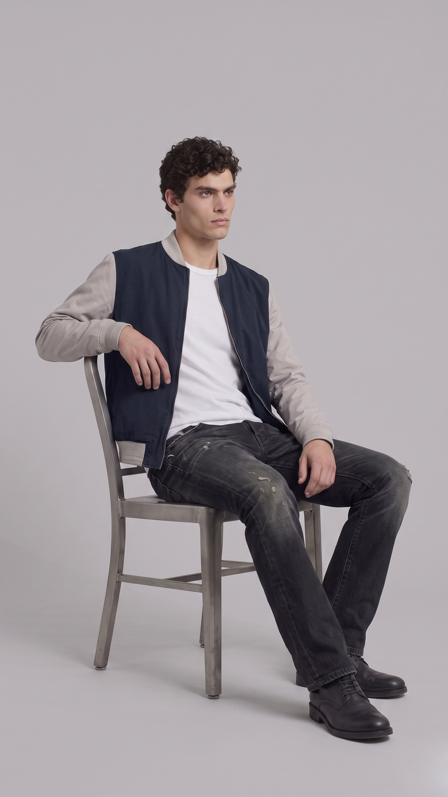 Men's casual streetwear look showcasing a modern two-tone navy blue and grey lightweight cotton jacket.