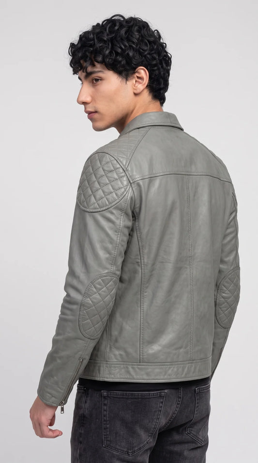 Back view of a charcoal grey leather utility jacket for men showing textured ribbed shoulder panels and reinforced main seams built to hold their shape for years
