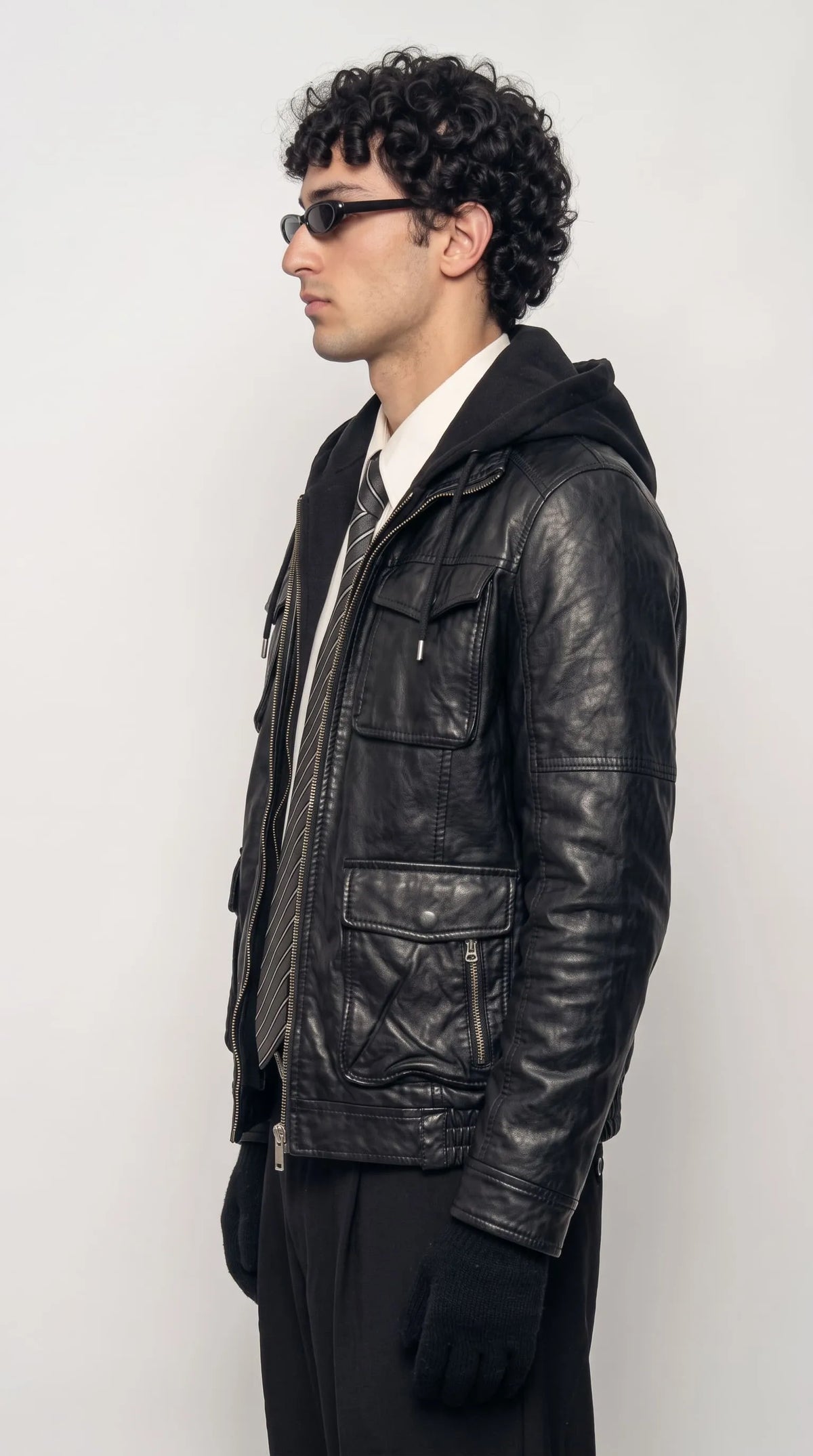 Side profile of a cheap yet stylish black leather jacket with hood for men, a budget-friendly leather hoodie jacket available on sale