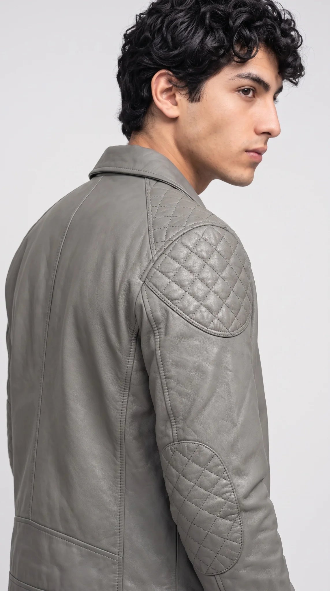 Close-up of soft semi-aniline grey leather grain and structured stitching on a cheap yet premium men’s genuine leather jacket available on sale