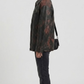 Urban streetwear casual styling featuring a vintage black distressed leather jacket with classic shirt-collar detail.