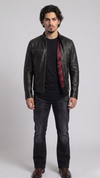 A professional studio front shot of the Jackero classic black leather biker jacket, showcasing its iconic asymmetric zipper closure and sharp lapels.