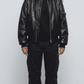 Front shot of a premium black leather bomber jacket from Jackero, showcasing the classic ribbed collar, waist hem, and a smooth silver front zipper.