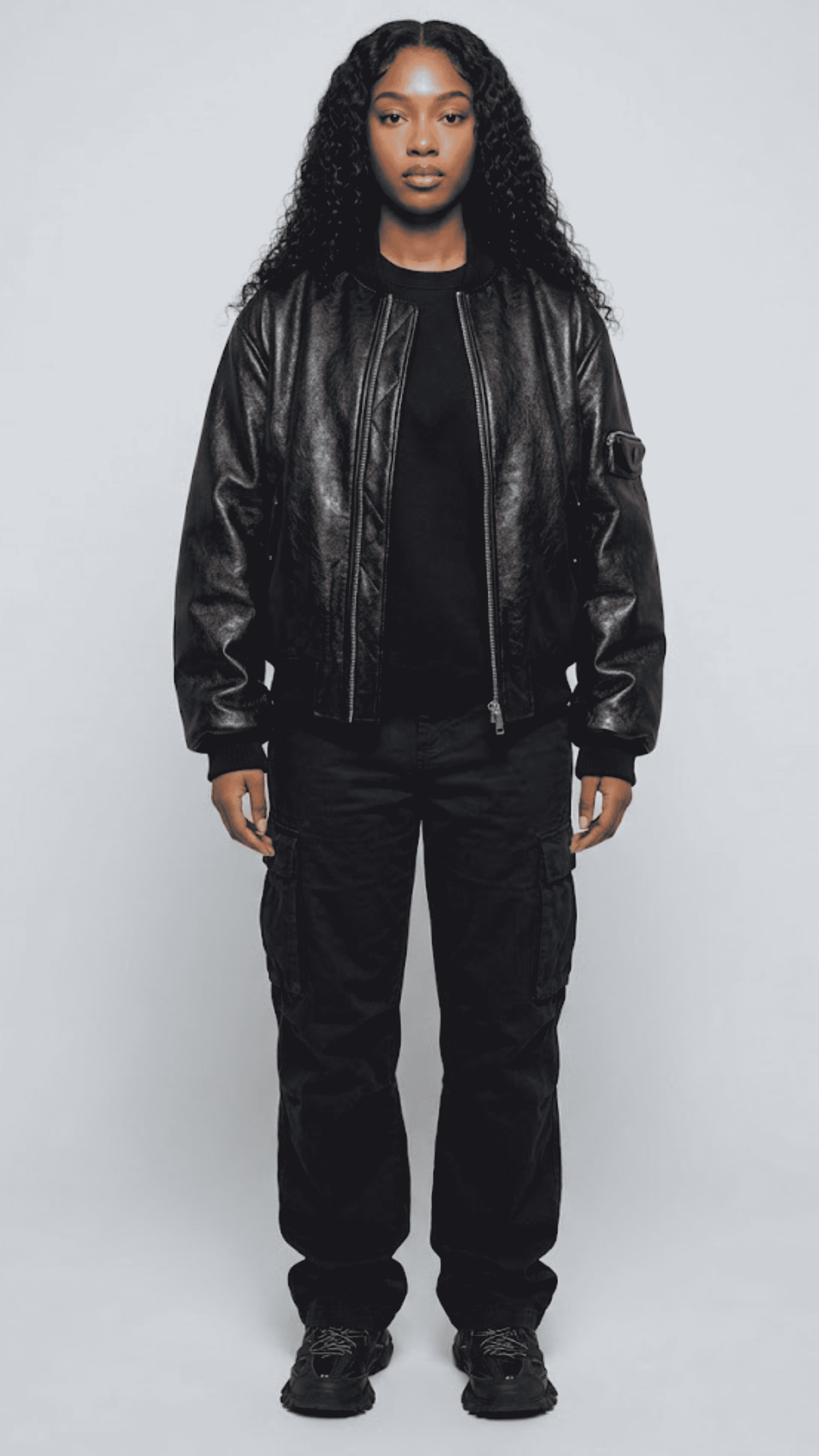 Front shot of a premium black leather bomber jacket from Jackero, showcasing the classic ribbed collar, waist hem, and a smooth silver front zipper.