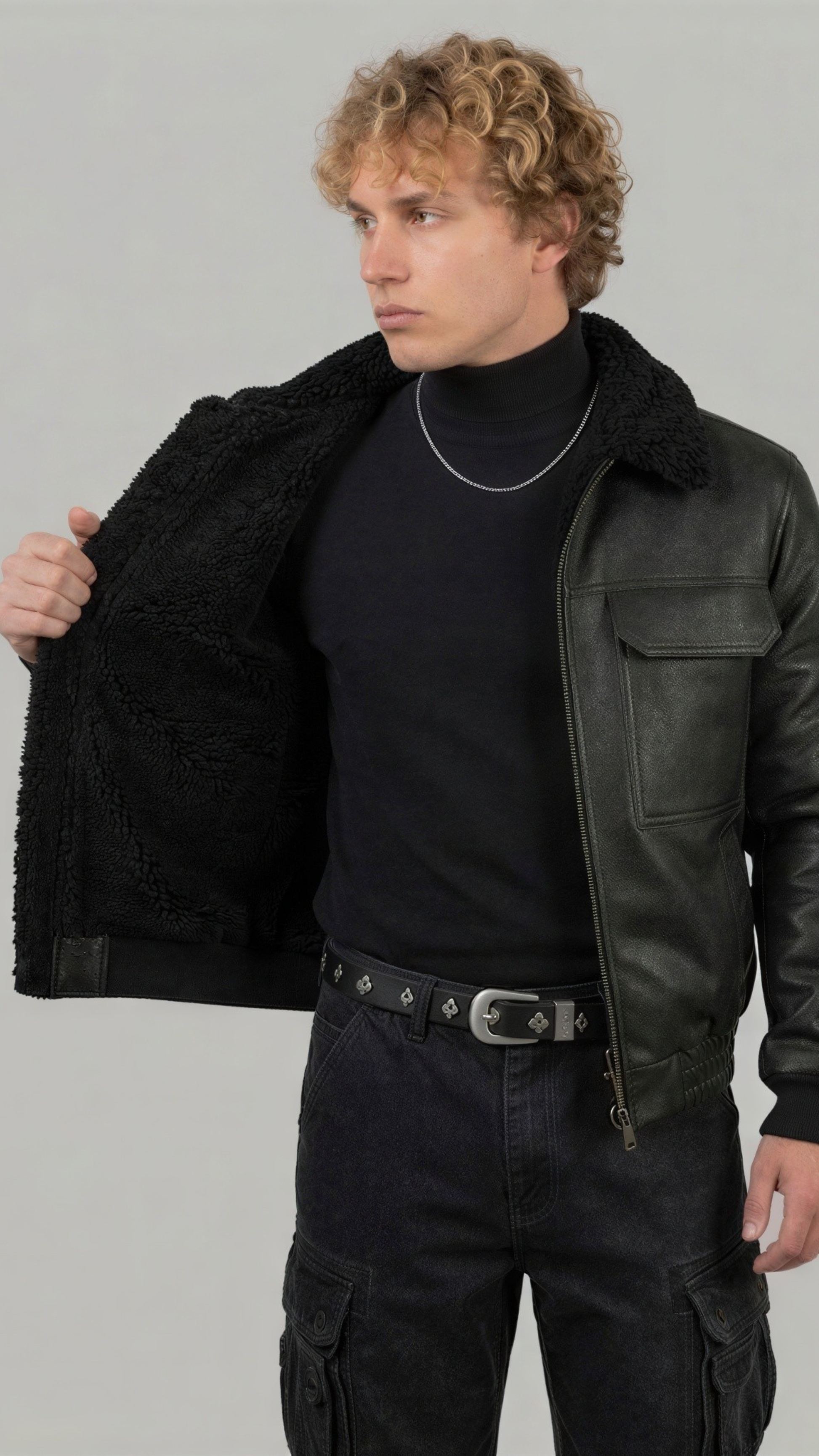 Stylish and warm all-black leather flight jacket with matching black shearling lining, ideal for winter outerwear.