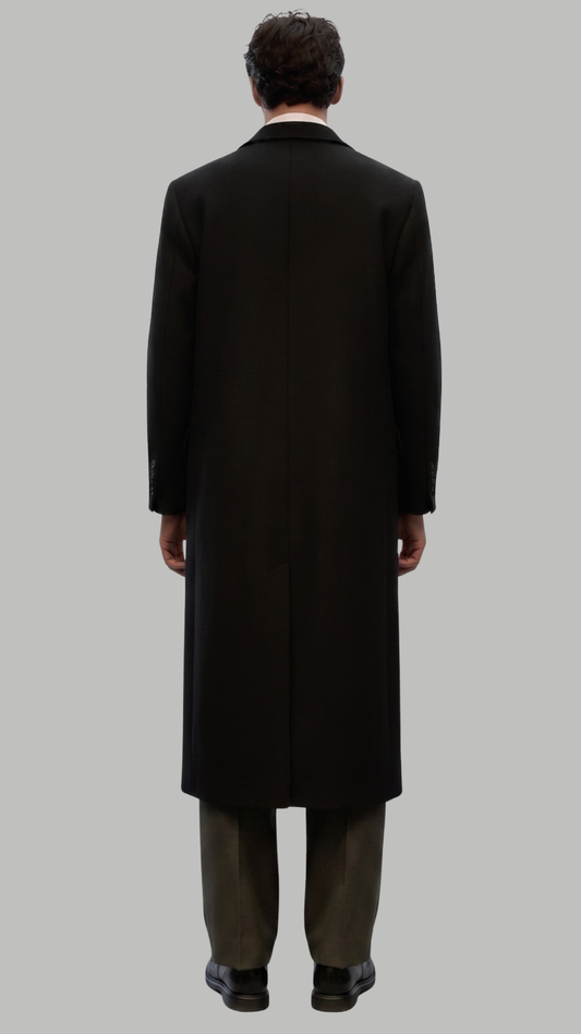 Full-length view of a sophisticated black long wool coat paired with formal attire.
