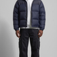 sleek dark navy blue puffer jacket with horizontal quilting design.