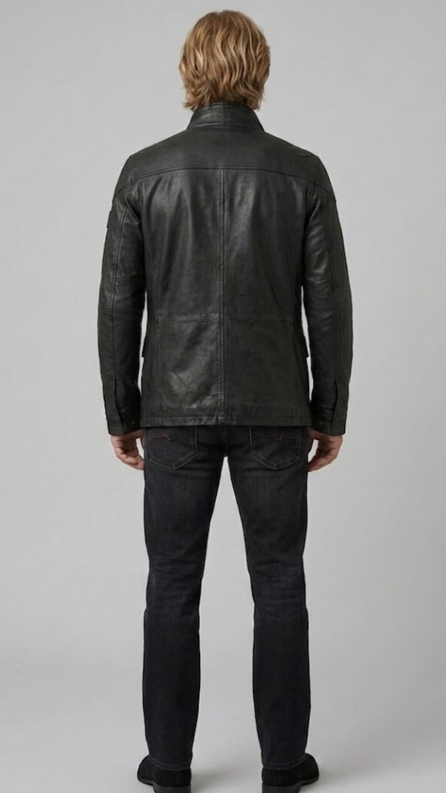 Versatile black leather field jacket layered over an urban outfit, perfect for combining practical utility with modern street fashion.