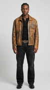 Vintage light brown distressed leather jacket shown from the front view in a studio setup.