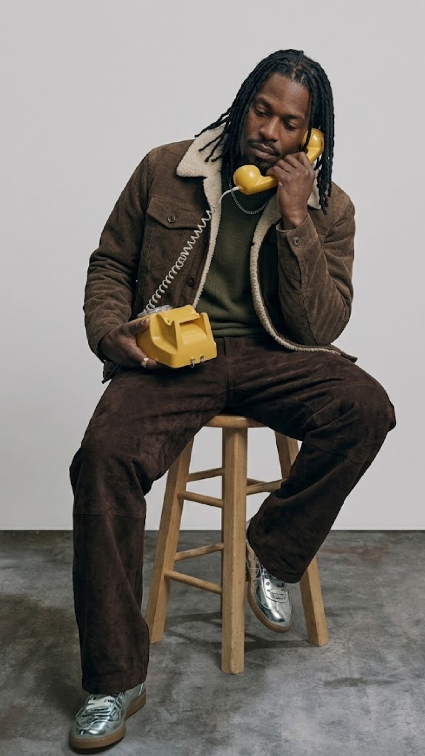 Men's classic dark brown suede trucker jacket with cream fur collar, perfect for winter fashion.