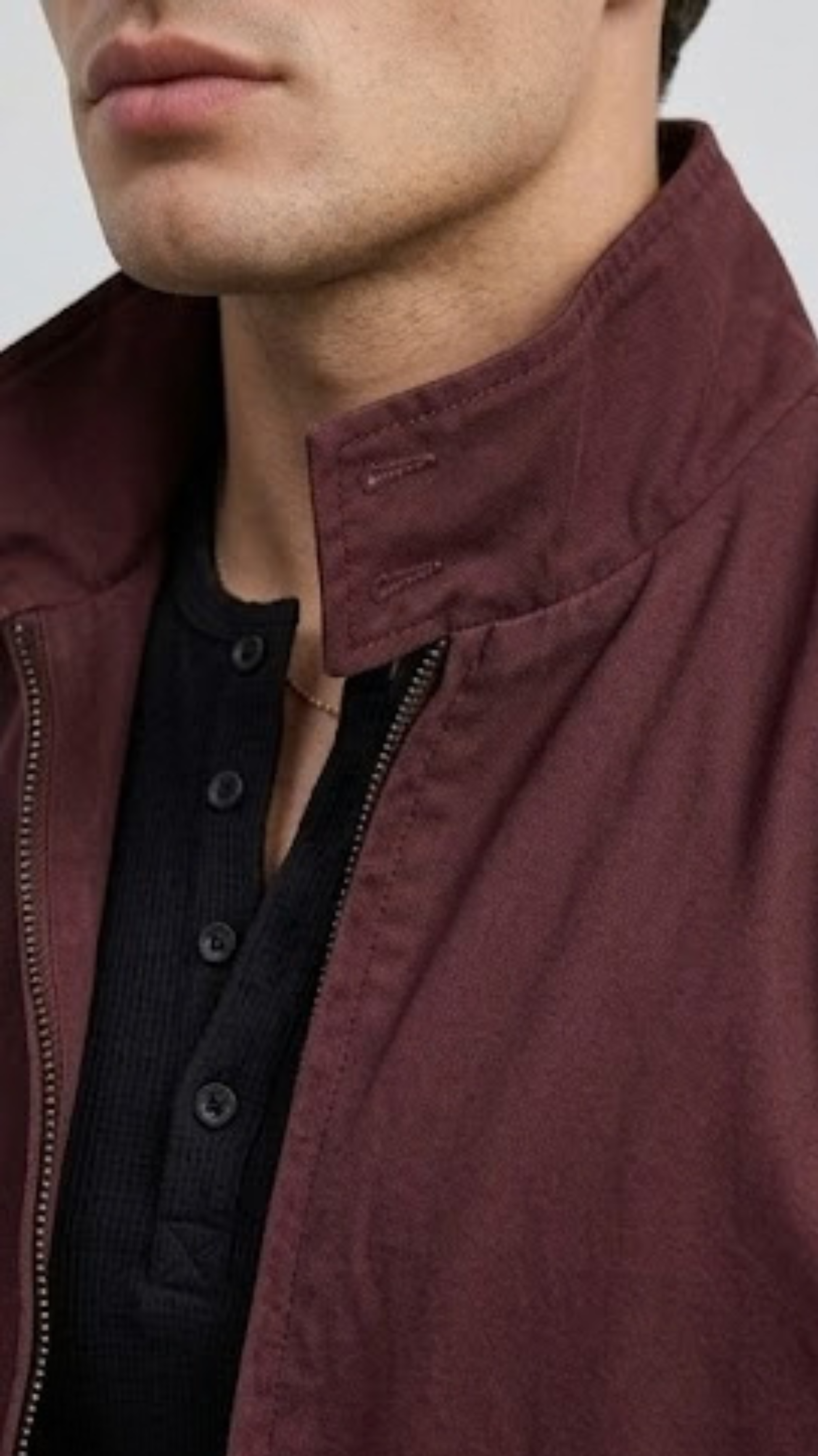 Close up shot of premium lightweight dark burgundy cotton jacket fabric texture