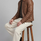 Rugged outdoor and urban street fashion statement featuring a classic chestnut brown leather jacket, ideal for layering in autumn and winter.
