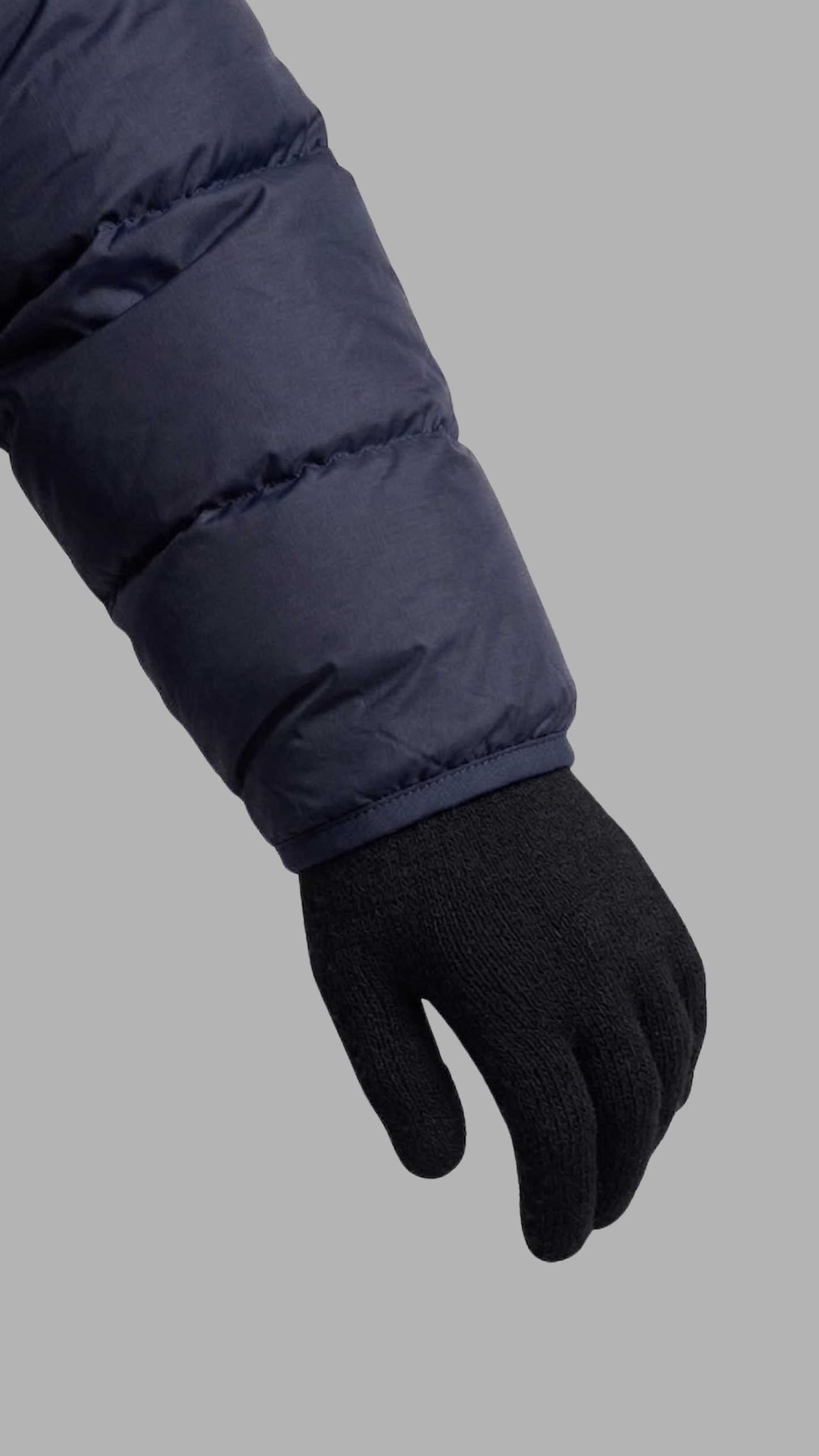 Close-up of the high-quality zipper and fabric texture on a navy blue winter puffer jacket.