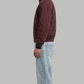 Model posing in a structured deep wine red cotton jacket for a smart casual look