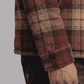 Close-up shot highlighting the soft woven flannel fabric texture with the warm plush inner shearling lining exposed.