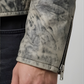 Close-up of a person wearing a camouflage-patterned jacket with a zipper.
