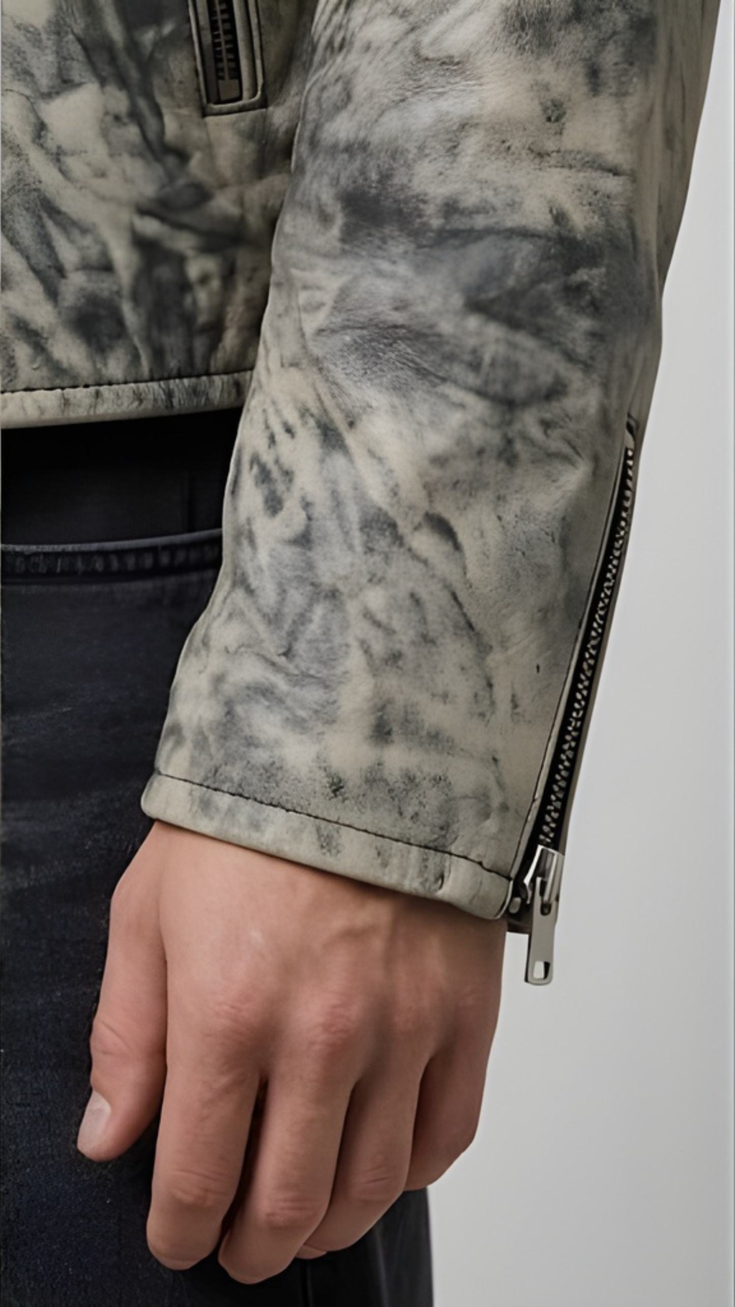 Close-up of a person wearing a camouflage-patterned jacket with a zipper.