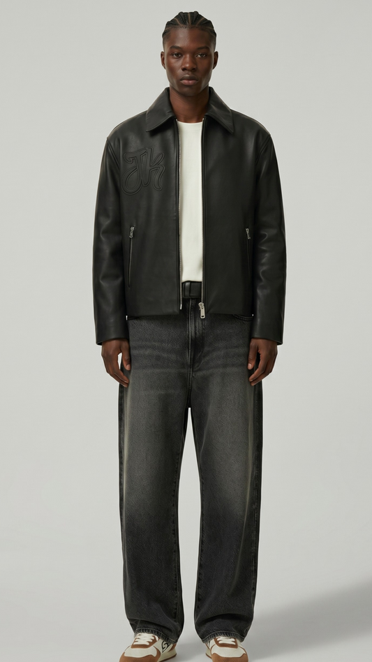 Front-on professional shot of a premium dark black leather harrington bomber jacket highlighting its classic fold-down collar and silver zip.