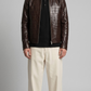 a premium jackero dark brown crocodile textured leather jacket showing the detailed croc-embossed pattern and high-quality stitching.