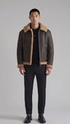 a dark brown leather aviator jacket featuring a rich tan shearling collar.