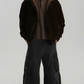 premium dark brown suede jacket with a matching soft brown shearling collar, standing against a clean grey background.