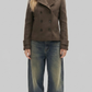 Full body view of a women wearing a dark brown short wool pea coat with a structured fit.