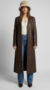 Full-length shot of a women wearing a dark chocolate brown leather trench coat.