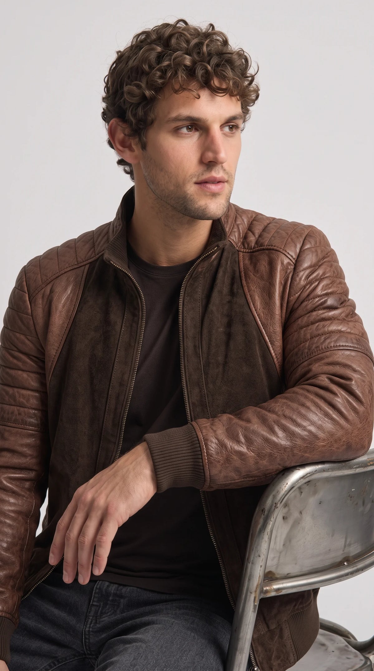 Dark cocoa-brown suede leather jacket featuring a neatly structured stand-up collar, precise seam stitching and a full-length metal front zipper, with a minimalist racer-inspired design suited to elevated casual outfits and modern city wear.