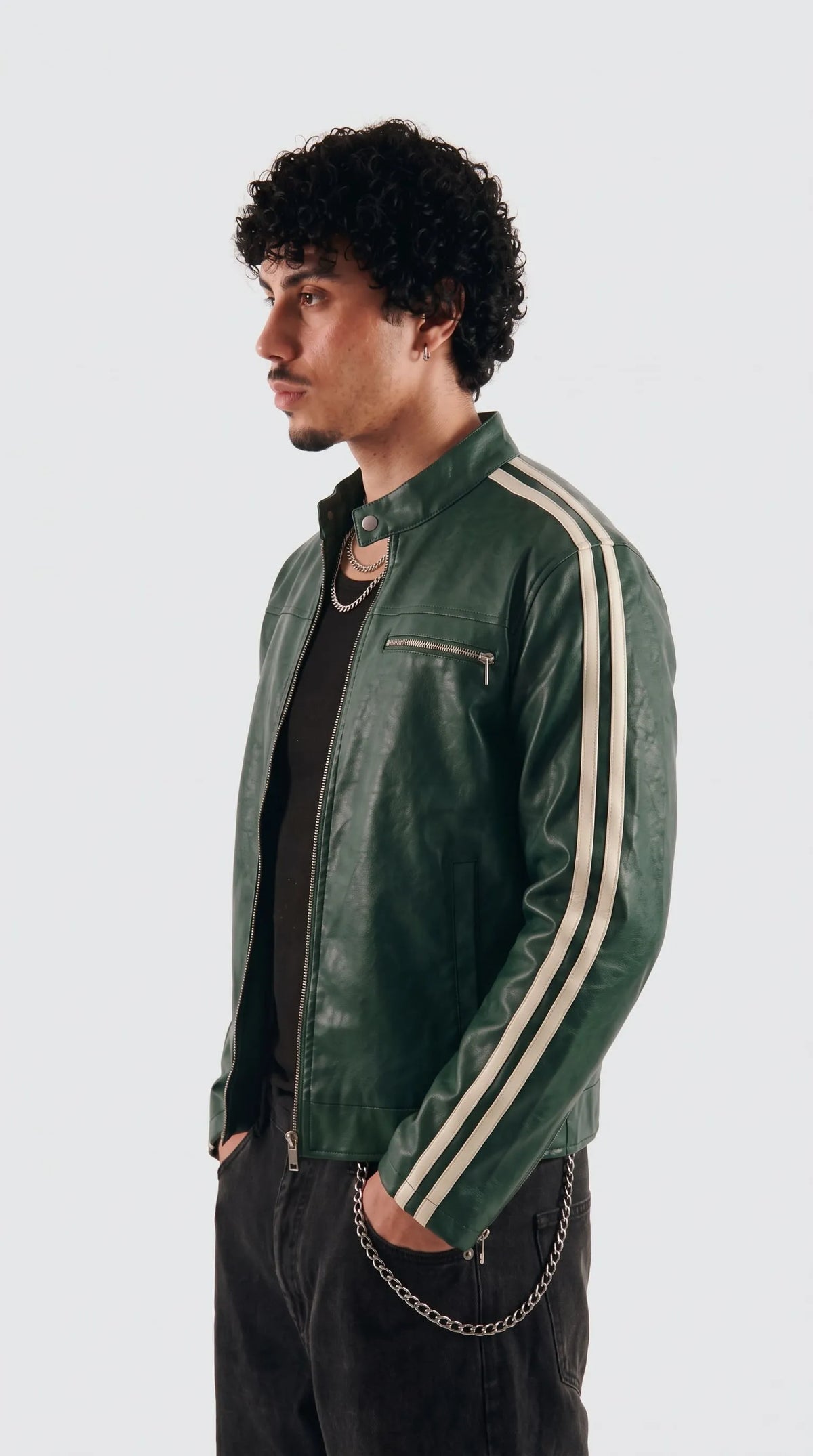 Close-up of the stand-up mandarin collar with snap-button closure on a bottle green leather cafe racer jacket, showing smooth semi-aniline leather grain