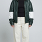 A professional studio front shot of the Jackero dark green oversized leather jacket, featuring bold white stripes along the sleeves and a clean zip-up front.