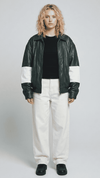 A professional studio front shot of the Jackero dark green oversized leather jacket, featuring bold white stripes along the sleeves and a clean zip-up front.
