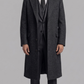 Front full-length view of a premium dark grey wool overcoat featuring structured shoulders and a classic button-down front.