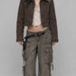 Front view of model wearing a dark khaki Y2K denim jacket with a soft fur collar and front button placket
