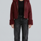 Front view lookbook catalog photo of a model wearing Jackero dark maroon suede aviator jacket with white shearling trim, paired with casual winter menswear.