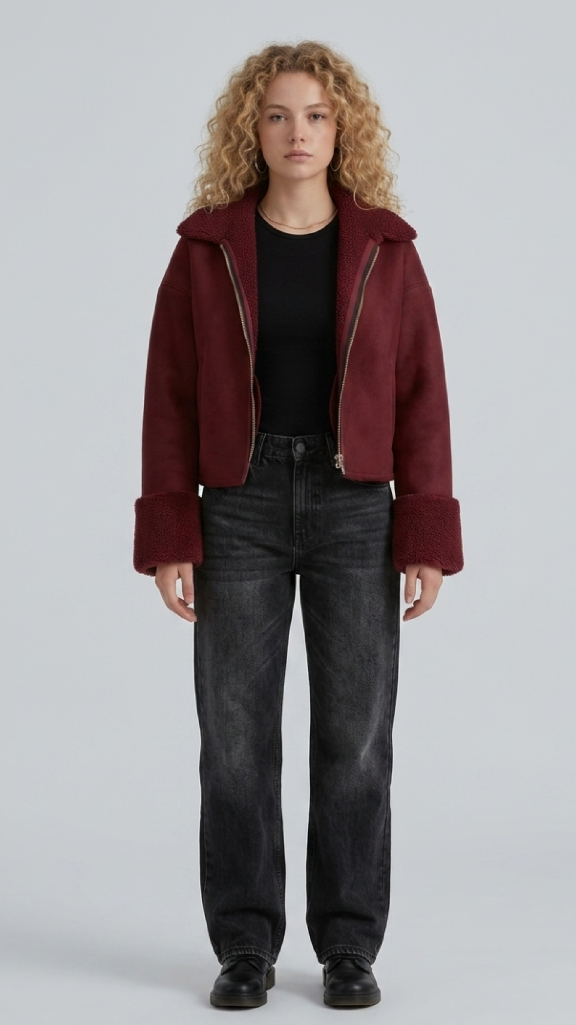 Front view lookbook catalog photo of a model wearing Jackero dark maroon suede aviator jacket with white shearling trim, paired with casual winter menswear.