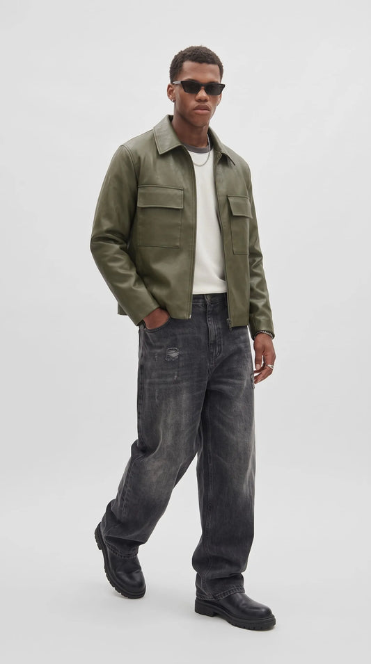 Olive green leather jacket styled as urban streetwear with white tee, silver chain and distressed black jeans