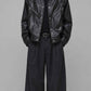 Front full view of a men's darkest black leather baggy jacket showcasing an ultra-deep jet-black shade and clean zip front.