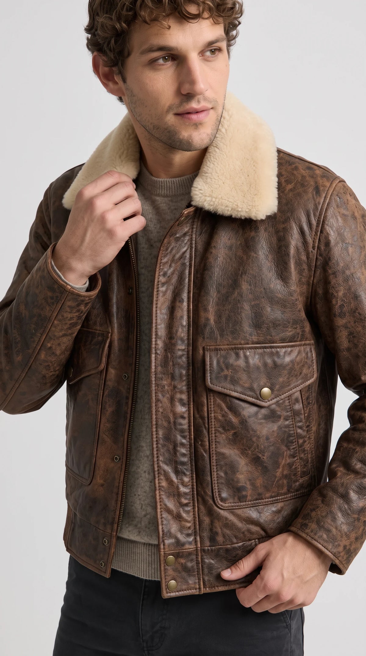 An uncompromising rugged outerwear piece, this Jackero rough-hewn chocolate brown leather bomber coat combines a heavily distressed texture with plush cream fur to dominate the underground fashion scene.
