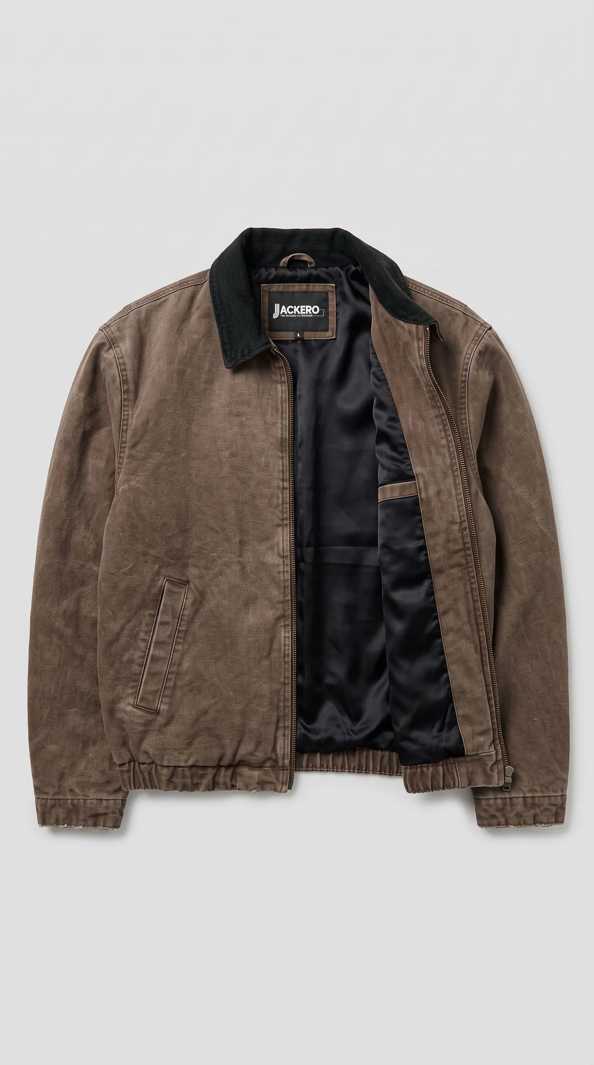 Distressed taupe-brown cotton canvas jacket with an acid-washed espresso finish, dark contrast collar, full-length zip closure and streamlined utility pockets, offering a versatile earth-tone statement for minimalist wardrobes and everyday layering.