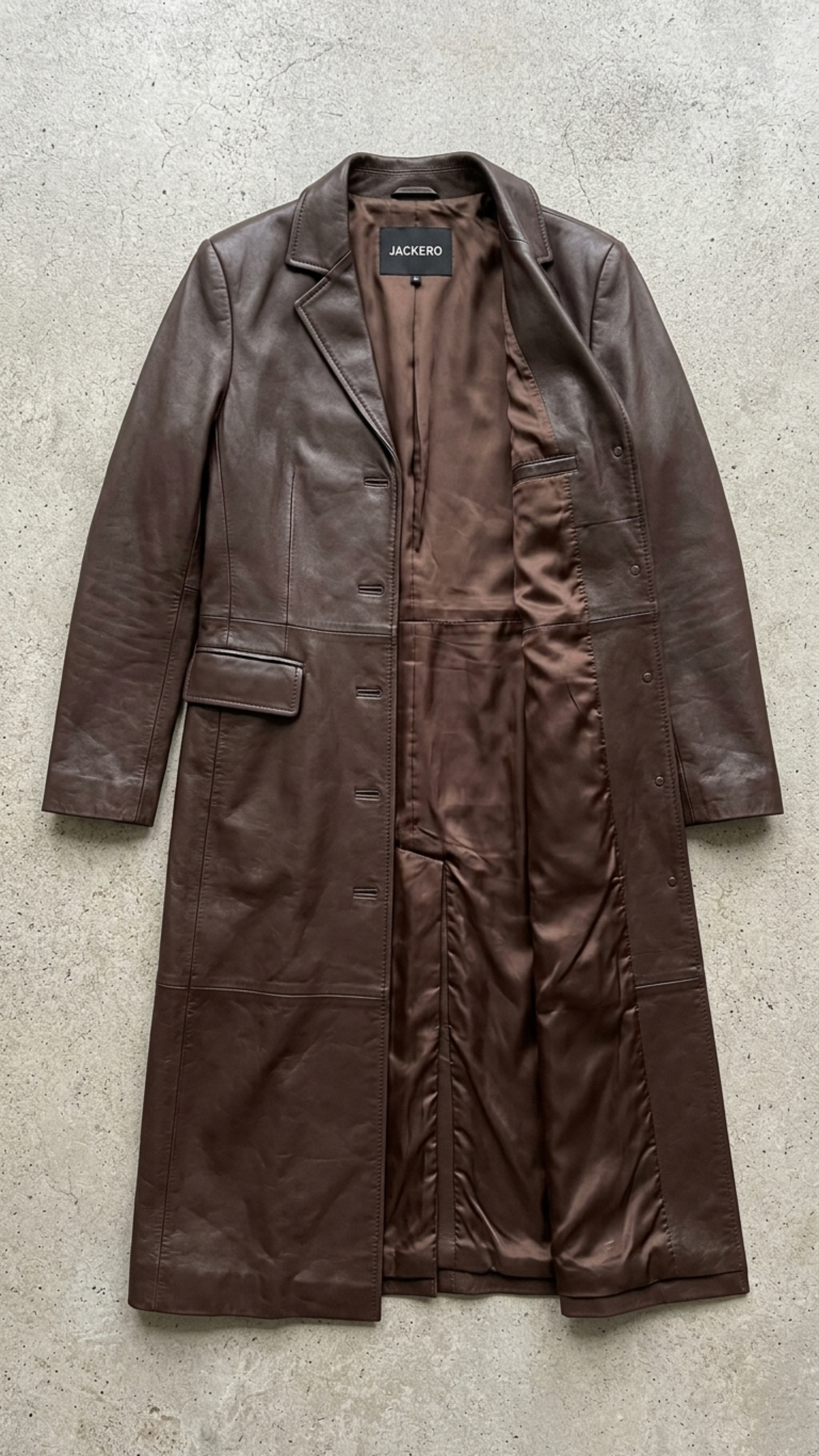 Detailed view of the lapels and button design on a high-quality chocolate brown leather overcoat.