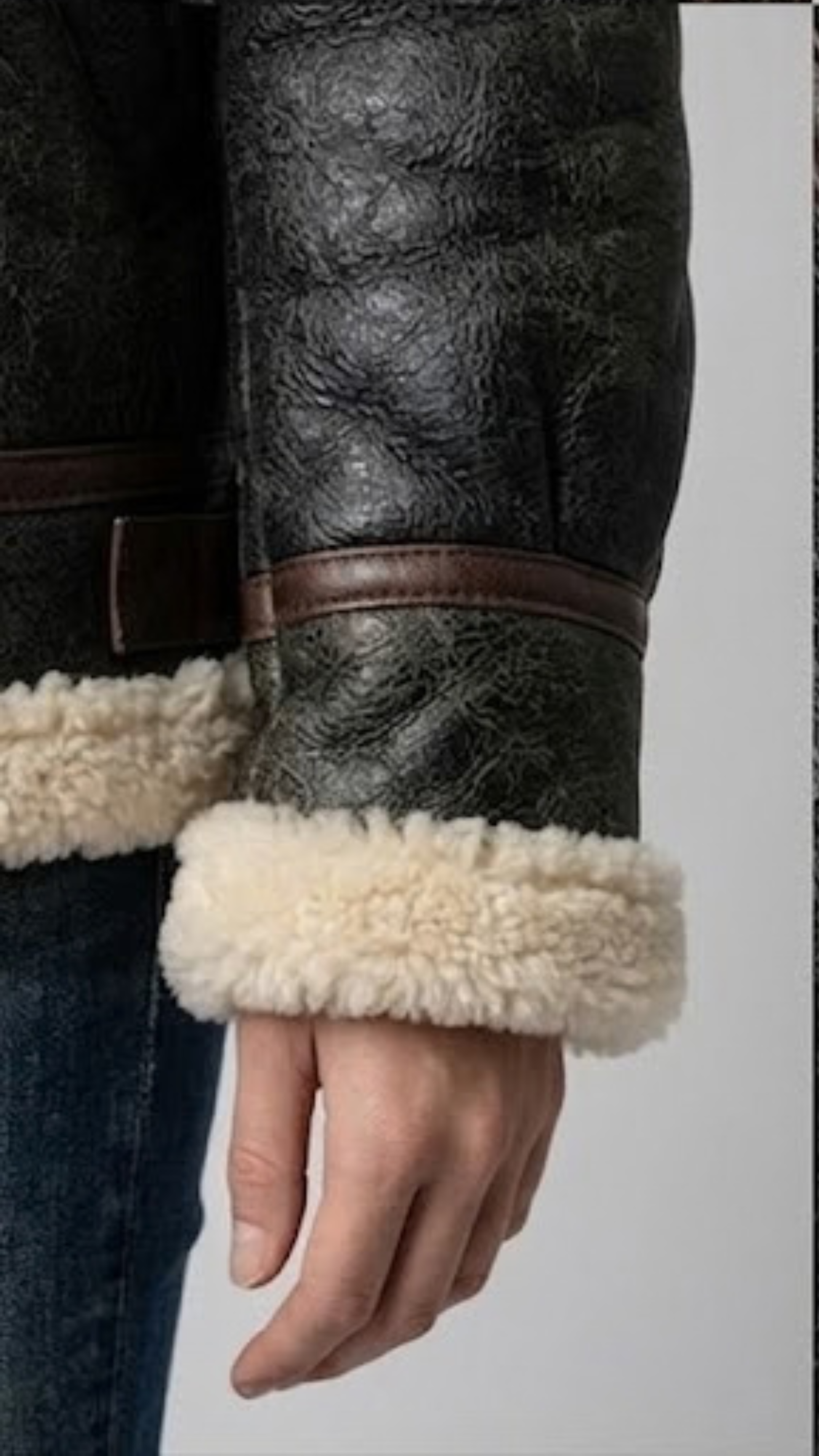 Detailed macro shot highlighting the rich texture of the soft faux cream fur lining against the premium black leather.