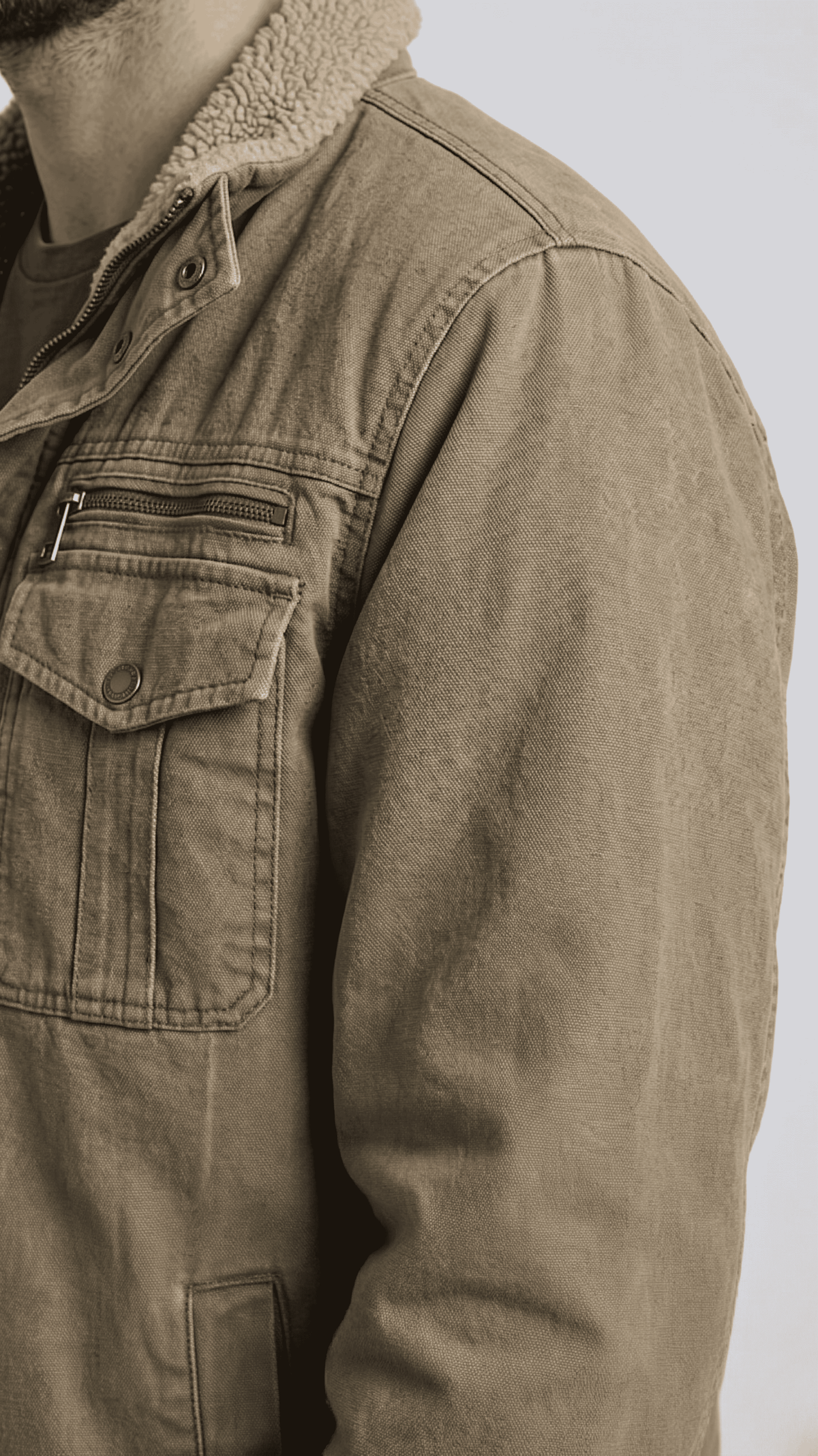 Close-up shot showing the thick, soft white shearling lining inside the high-quality rugged olive cotton fabric.