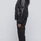 a model styled in a casual women's black leather bomber jacket with a clean t-shirt and sneakers.