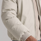 Detailed view of the zip closure and quilting pattern on a white fur-trimmed puffer jacket.