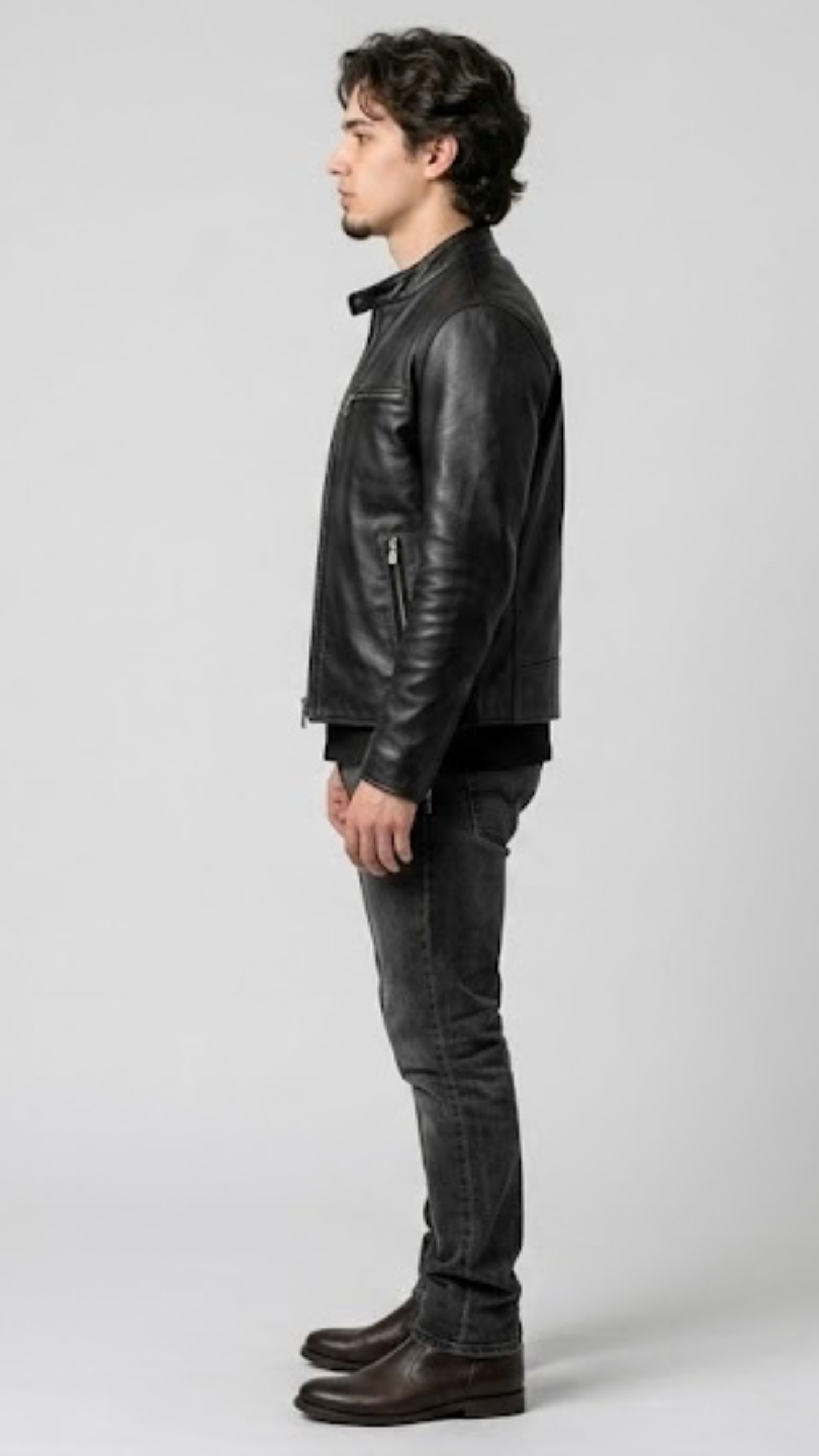 classic snap-button collar, lapel construction, and zippered chest pockets of a black leather biker jacket.