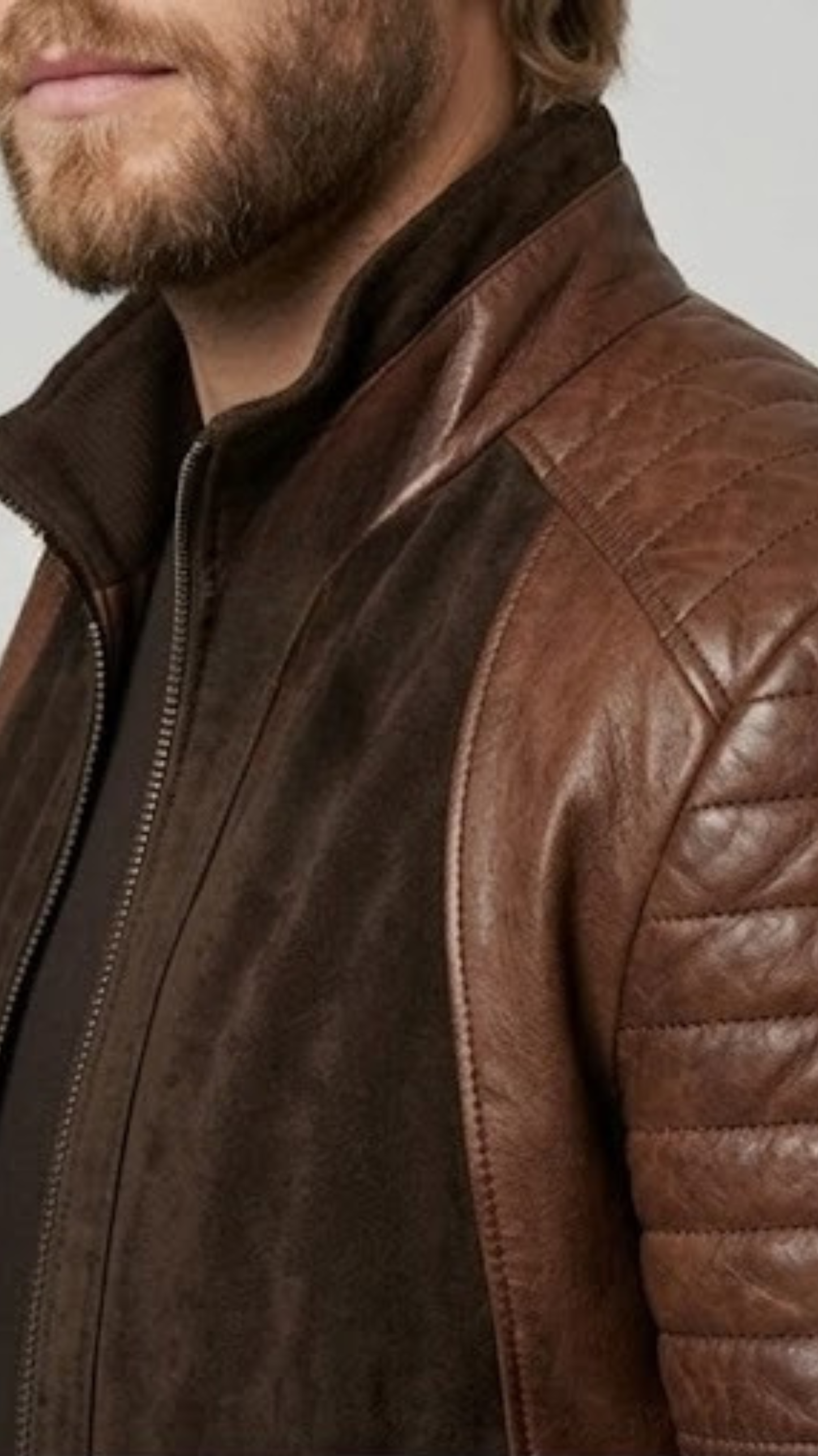 Close-up micro detail focusing on the premium soft texture of dark chocolate brown suede and the intricate quilted stitching pattern.